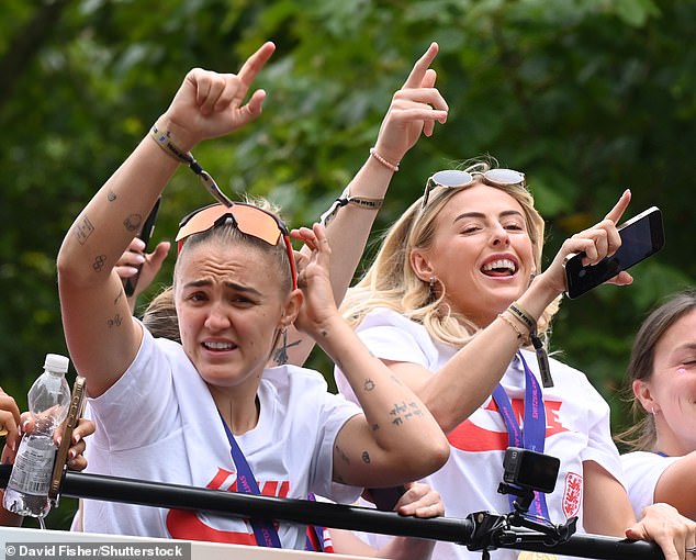 The squad - including penalty scorer Kelly - waved to fans and filmed the parade for themselves as they rode towards Buckingham Palace