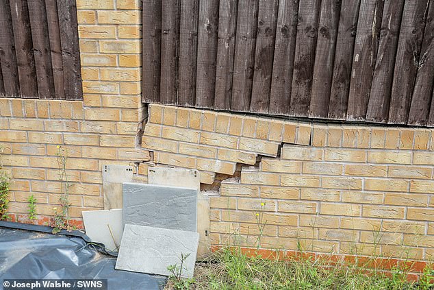 Cracks in the wall of Mr Kumar's garden, he claims it was caused by work carried out by developers