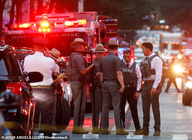 FDNY personal, NYPD police officers and emergency vehicles are on the scene after a gunman armed with a rifle opened fire in the lobby of the building on 52nd Street and Park Avenue