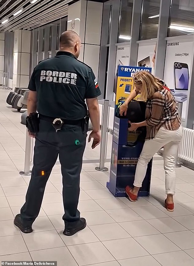 Pictured: Ms Kalinina tries to show her bag fits into the sizer