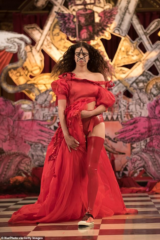 Models wearing devil horns and displaying upside-down crosses paraded down the aisle-turned-catwalk of St Andrew Holborn church for a London Fashion Week event in 2017