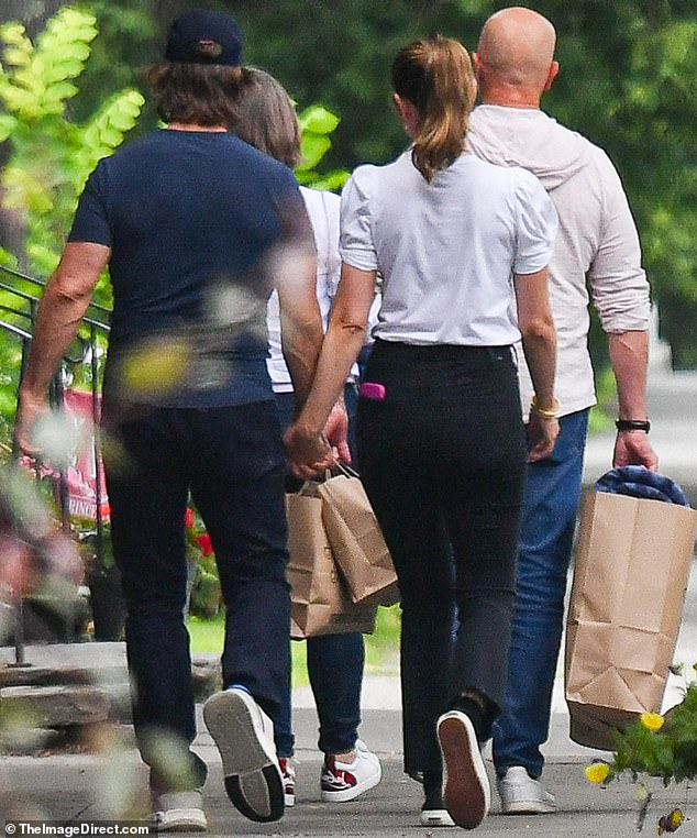 She tucked her shirt into a black pair of fashionable cigarette trousers
