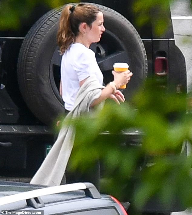 Her silky brown hair was swept back into a ponytail