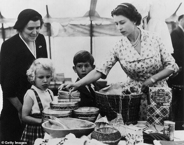 The late Queen with a young King Charles and Princess Anne. Gyles Brandreth claims that Elizabeth's love of washing up started at a young age
