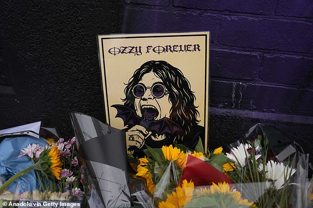 Flowers, notes and floral tributes on the Black Sabbath Bridge bench are seen in Birmingham