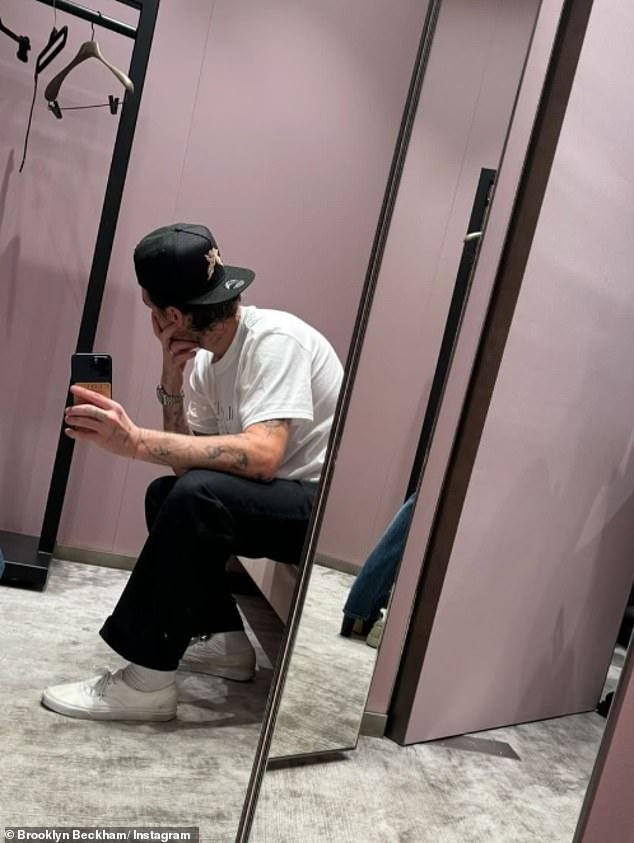 He wore a white printed T-shirt - featuring his brand's logo - and dark trousers