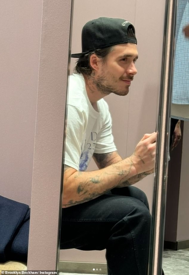 Brooklyn cut a casual figure as he posed for selfies in a changing room while waiting for Nicola