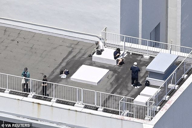 People who evacuated to the rooftop of a building in Kushimoto, Wakayama Prefecture, western Japan, on July 30, 2025