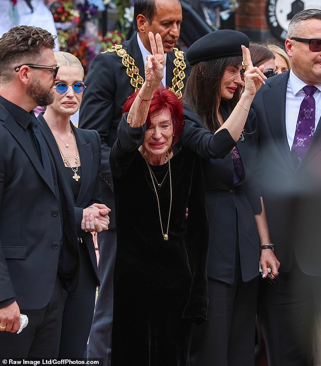 As the fans cheered for her and called her name, Sharon threw up a peace sign - alongside eldest daughter Aimee (right)