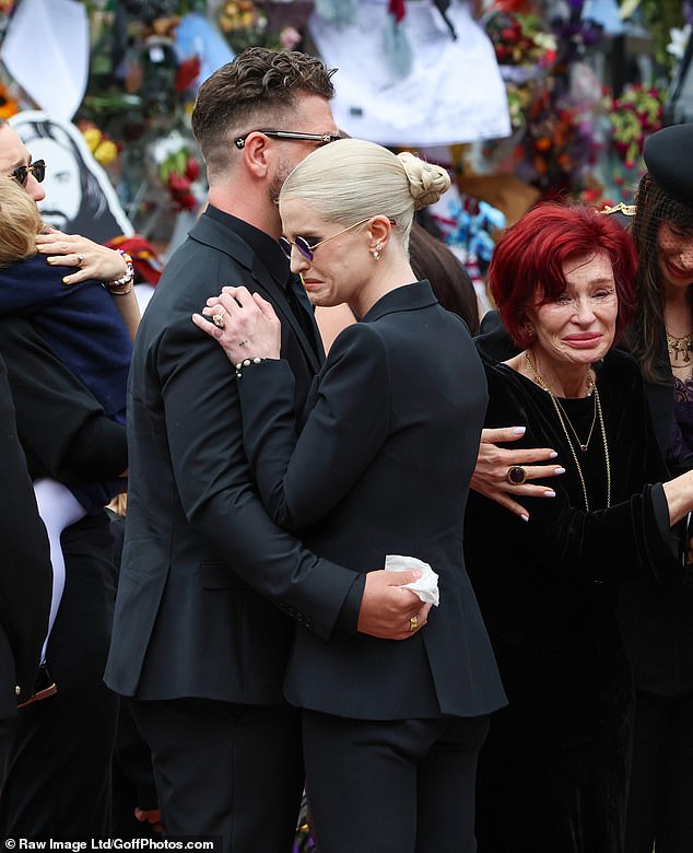 Jack and Kelly Osbourne share an embrace as Sharon is comforted by Aimee during the hell-raiser's final send-off
