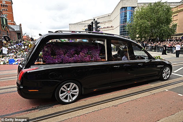 The hearse carrying the singer's coffin was adorned with purple flowers spelling out 'Ozzy'