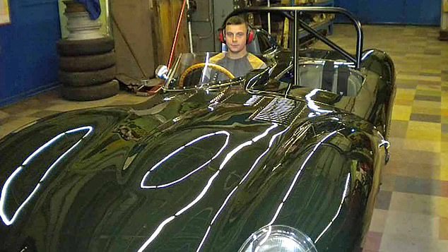 Walpole at the wheel of a vintage car, believed to be in his grandfather's workhop