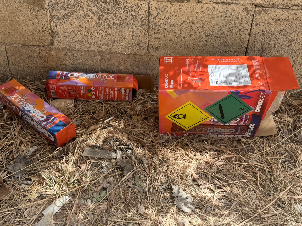 Discarded nitrous oxide canisters on the ground.