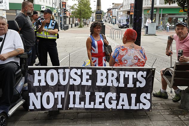 Thousands of protesters gathered outside the 19 flat development this evening blasting The Beatles and waving St George's Flags and placards reading 'Locals In Illegals Out'