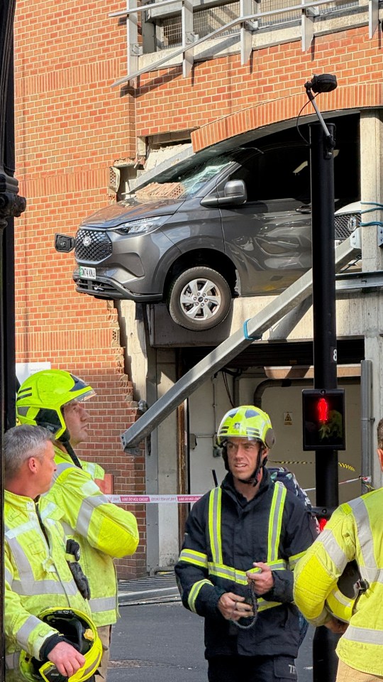 Car crashes through multi-story car park, injuring pedestrians.