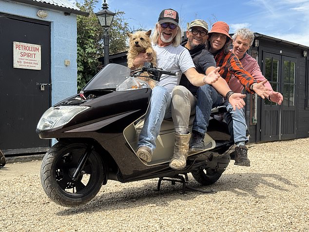 Henry Cole and his Shed And Buried team are seen here with a pet dog named Jelly Bean
