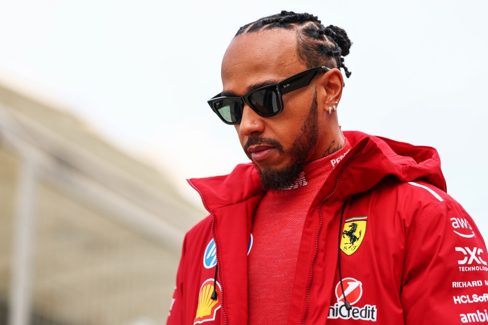Lewis Hamilton in a red Ferrari jacket.