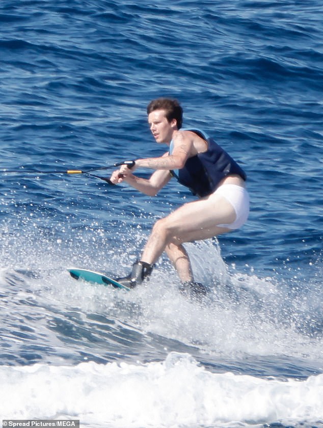 He kept them on for a spin around the bay on a wake board, showing off his water sports skills before also flaunting his musical talent with a guitar session