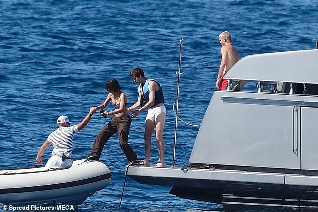 Cruz helped his girlfriend onto a smaller tender