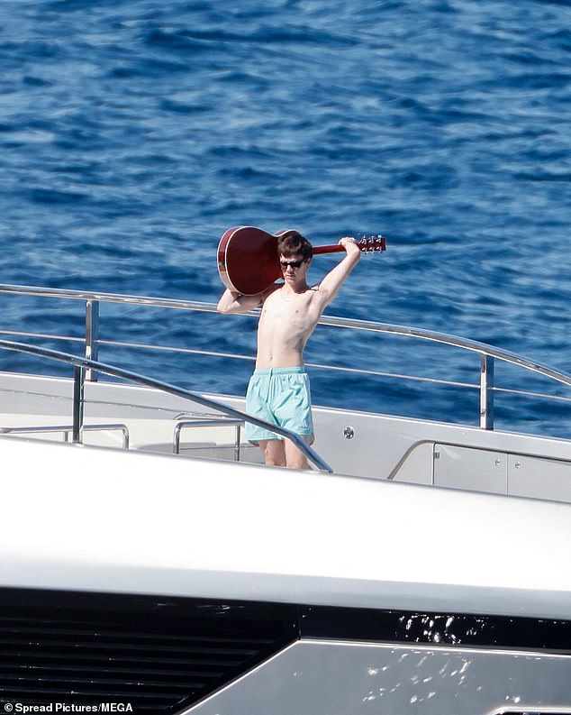 The son of Victoria and David slung the guitar over his shoulder