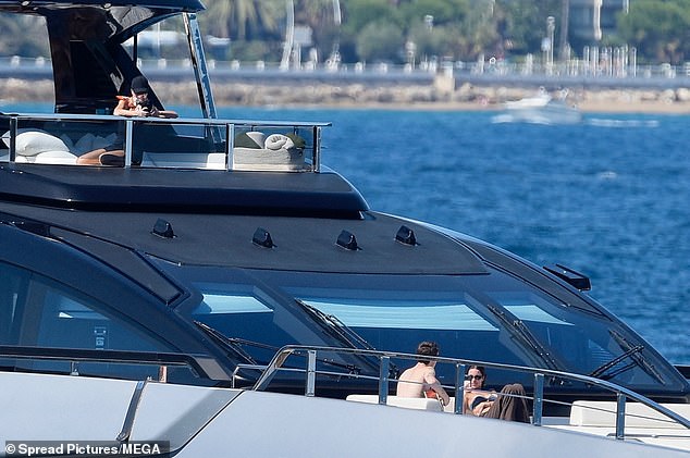She held her phone over the side of the boat
