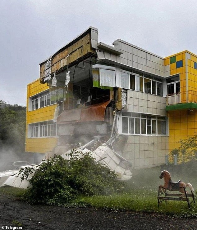 Rescuers in Russia are pictured inspecting a kindergarten damaged by a massive earthquake on Tuesday