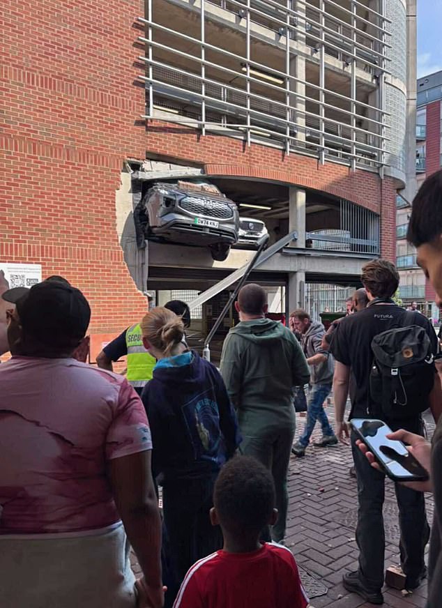 The van was left dangling from the second floor of the building as emergency services were called to the scene at around 4.10pm on Wednesday