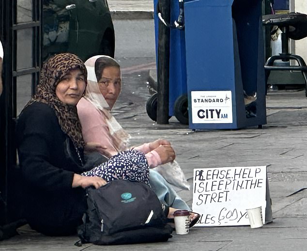 Homeless people begging next to Marble Arch