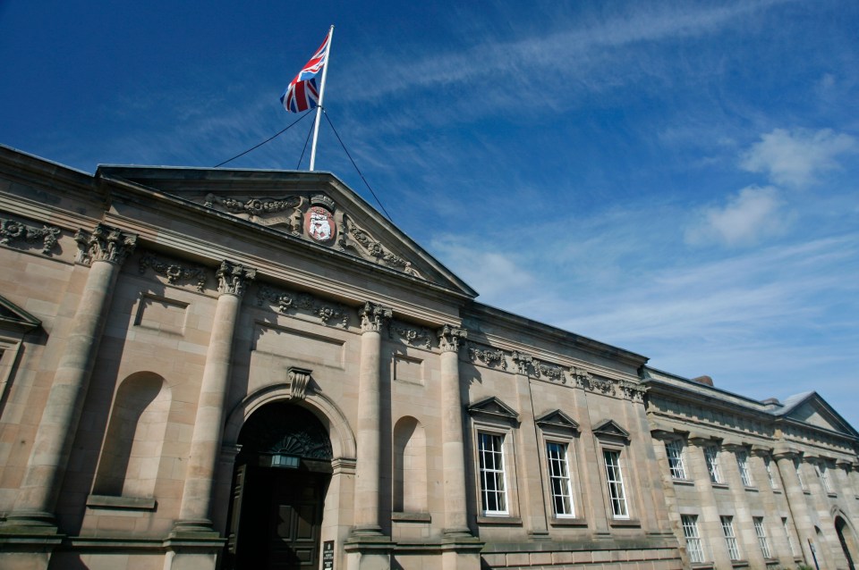 Warwick Crown Court building with a Union Jack flag.