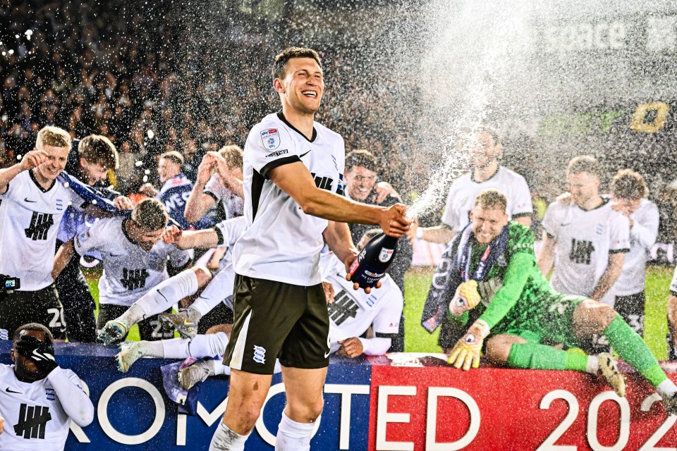 Birmingham City players celebrating promotion, spraying champagne.