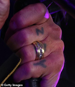 The distinctive piece of jewellery is believed to be Ozzy's wedding band, and he has been seen wearing it on his ring finger in recent years