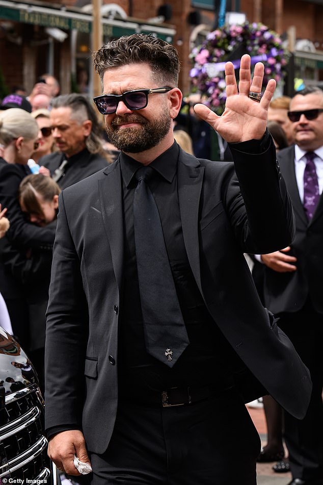 In another poignant clothing choice, Jack, 39, also wore a small silver cross pin on the end of his tie - a reference to Ozzy's signature pendant
