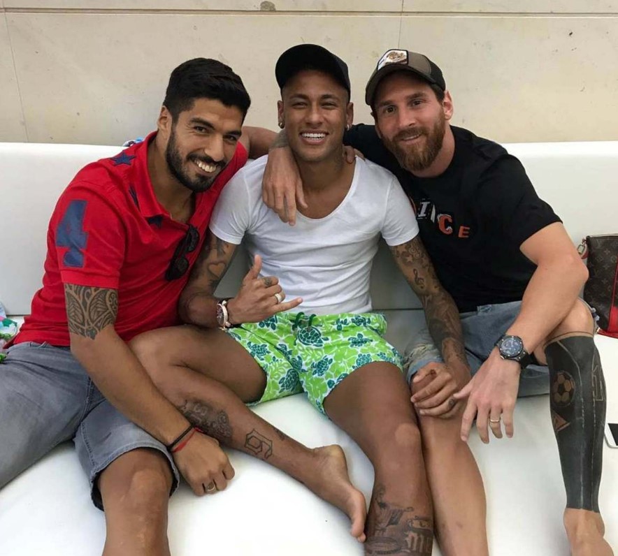 Three soccer players sitting together.