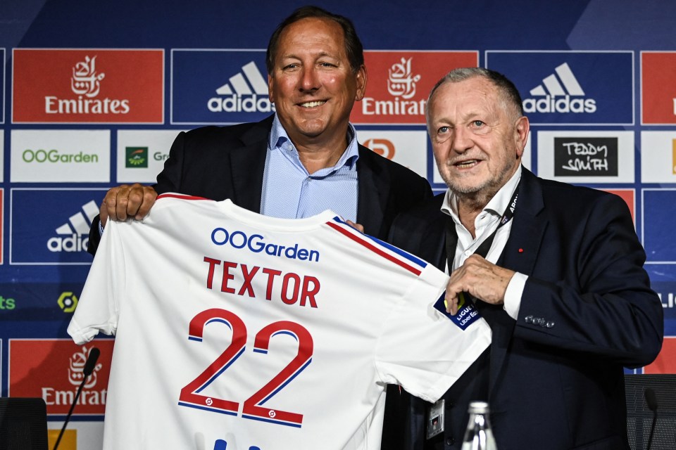 John Textor and Jean-Michel Aulas holding a soccer jersey.