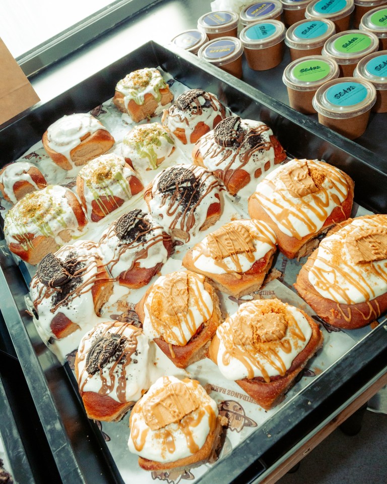 Tray of various decorated cinnamon rolls.