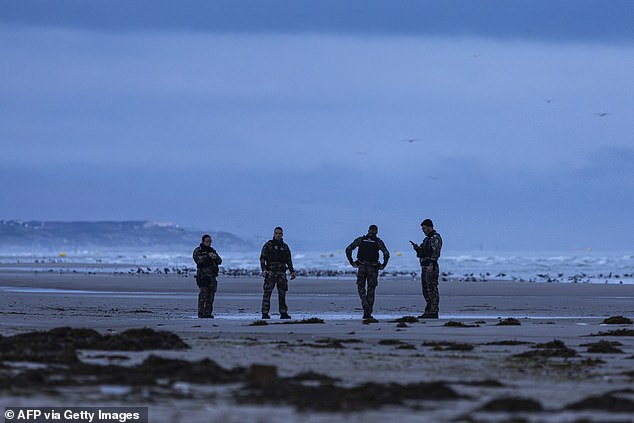 French gendarmes patrol the beach at Equihen in northern France yesterday evening