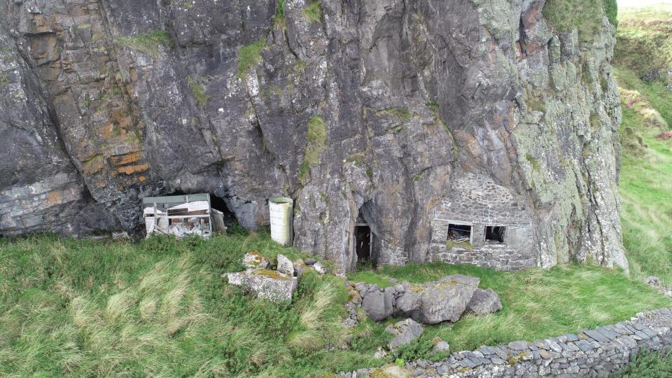 Structures built into a cliff face in Insh Island, Scotland.