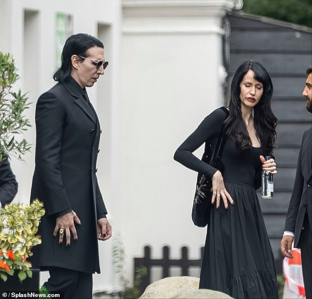 Manson wore an all-black outfit, as did his wife