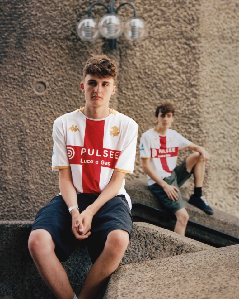 Two young men in Genoa soccer jerseys.