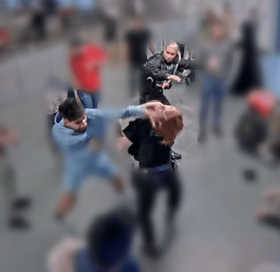 A blurry photo of a fight between several people.