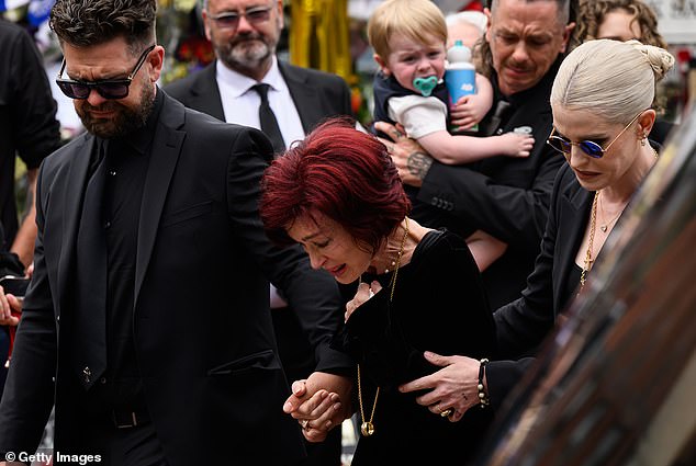 Sharon paid a subtle tribute to her late husband during the ceremony as she wore Ozzy's ring around her neck (pictured with son Jack and daughter Kelly)