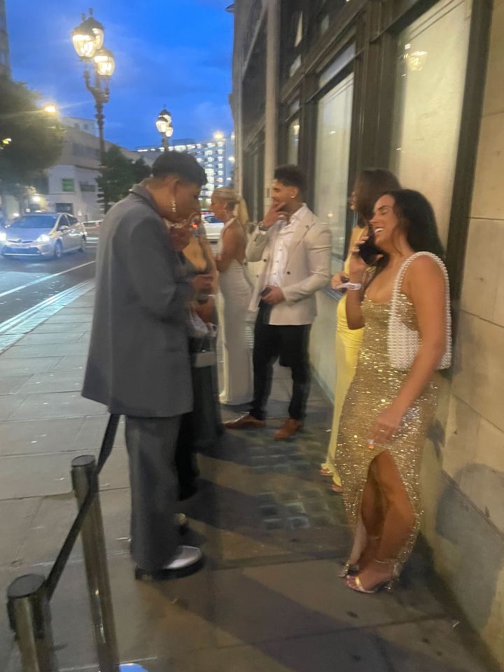 Group of people standing outside at night.