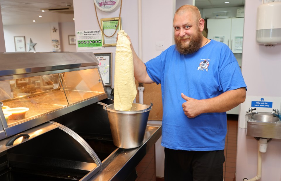 A man preparing batter for fish and chips.