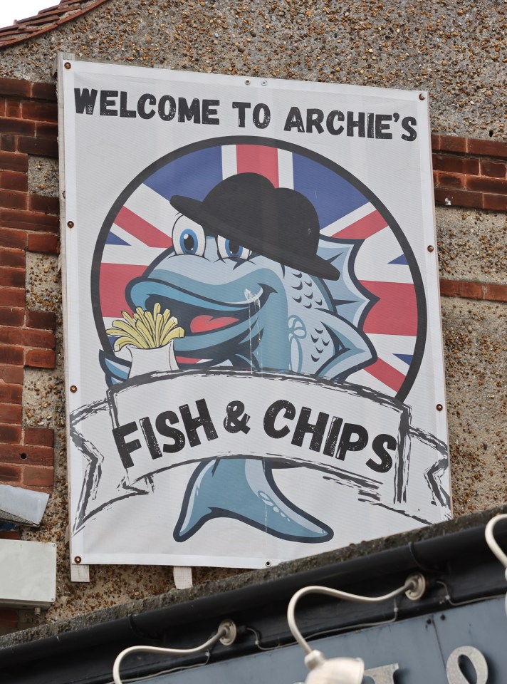 Illustration of a fish wearing a bowler hat holding fish and chips, with a UK flag backdrop; Archie's Fish & Chips.