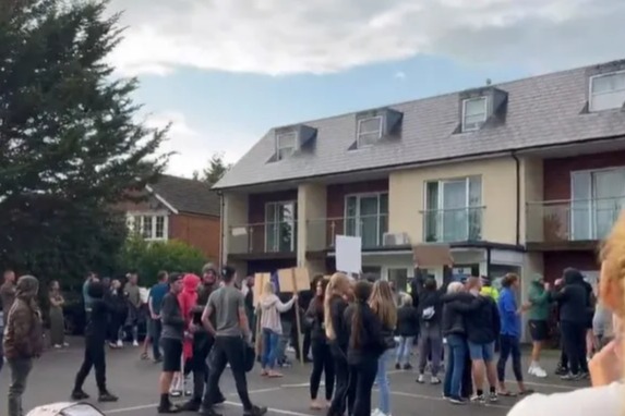 Protestors demonstrating in front of a building.