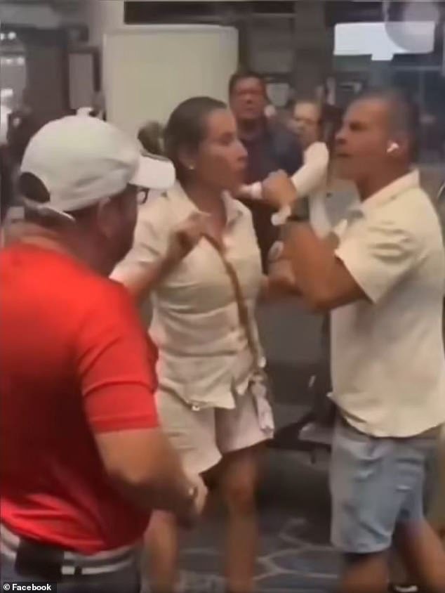 Karen de Santacruz (center) stood between a passenger (left), who came to the aid of a woman her husband (right) had slapped after ordering the woman to get up from the seat