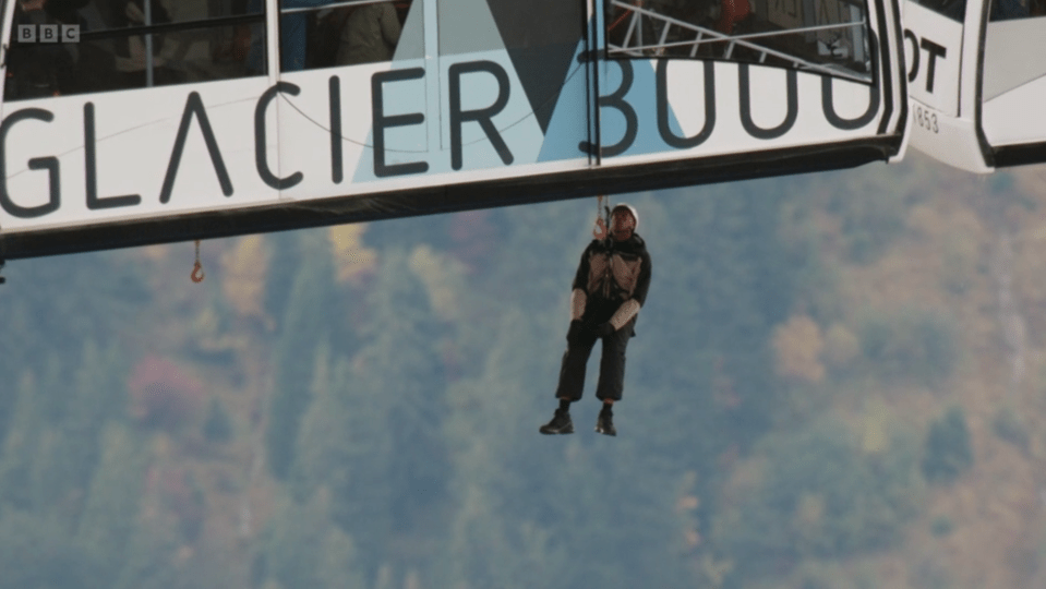 Person dangling from a Glacier 3000 cable car.