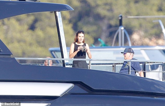 Gordon's wife Tana looked effortlessly chic in a black sundress and appeared to be in good spirits as she laughed and joked with the group