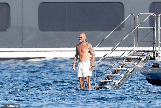 David put his tattooed physique on display as he enjoyed a dip in the ocean during the trip
