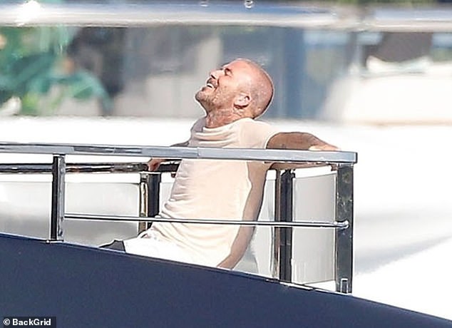 David appeared to be having the time of his life as he smiled and looked very relaxed while soaking up the sun